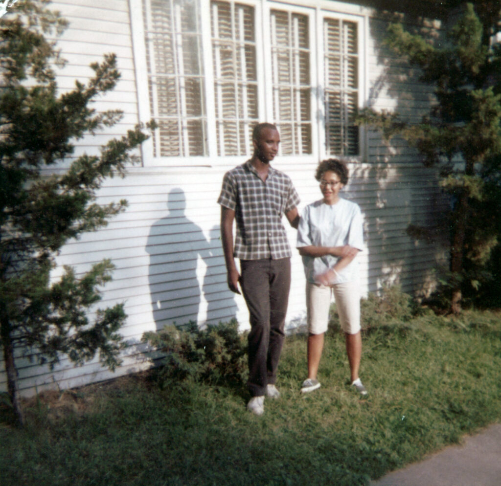 Mom and Dad in a backyard and super young